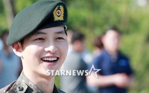 Smiling soldier wearing a green beret.