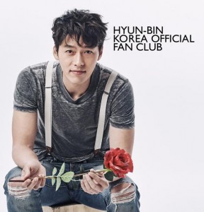 Man holding a rose, smiling warmly.