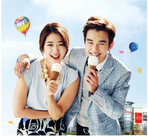 Happy couple enjoying ice cream outdoors.