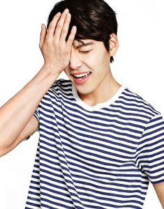 Smiling person covering face with hand.