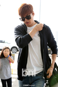 Person in sunglasses walking at airport.