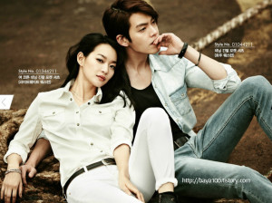 Couple posing casually in stylish outfits.