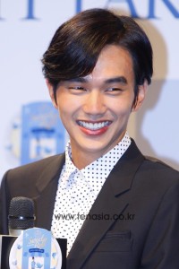 Smiling man in formal attire at event.