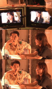 Actors on set discussing a scene.