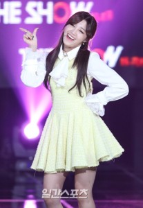 Smiling performer in a yellow dress.