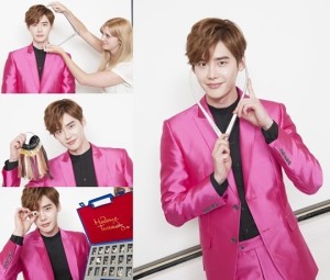 Person in pink suit with stylist preparing.