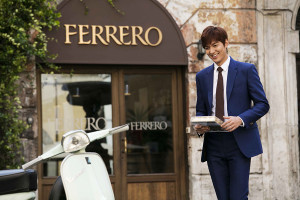 Man in suit outside Ferrero shop.