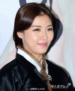 Woman in traditional clothing smiling brightly.