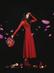 Fashion model in red dress with flowers.