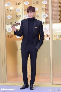 Man in suit holding a model airplane.