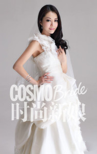 Bride posing in elegant wedding dress.