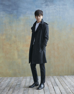 Man in a black trench coat and trousers.