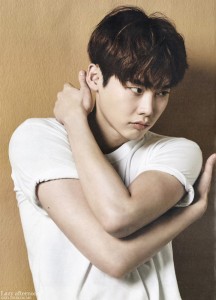 Young man in a white shirt, thoughtful pose.