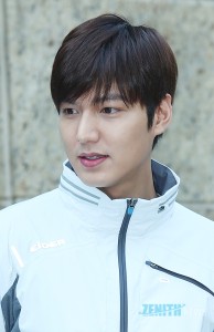 Young man in a white jacket outdoors.