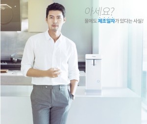 Man standing next to a water dispenser.