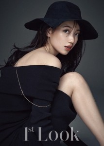 Stylish woman in black hat and sweater.