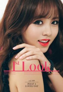 Smiling woman with brown hair and makeup.