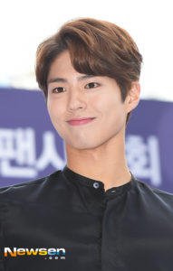 Smiling young man in stylish black outfit.