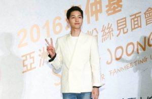 Young man posing with peace sign.