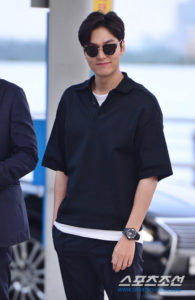 Man in sunglasses wearing a black polo shirt.