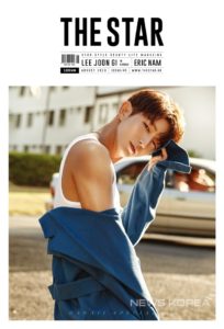 Model posing in blue jacket outdoors.