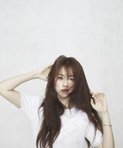 Young woman with long hair in studio.