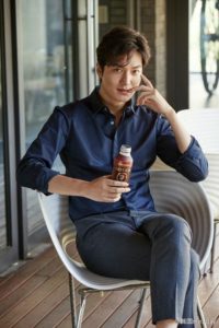 Young man sitting with a drink.
