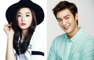 Two smiling individuals in stylish outfits.