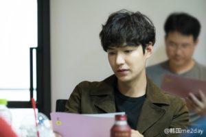 Person reading a script in a meeting.