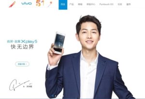 Man in suit holds smartphone, promoting Vivo.
