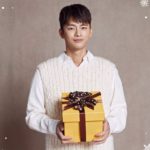 Young man holding a gift box.