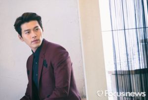 Man in stylish suit looking thoughtfully.