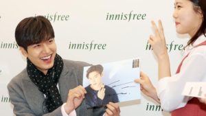 Fan meeting with signed photograph exchange.