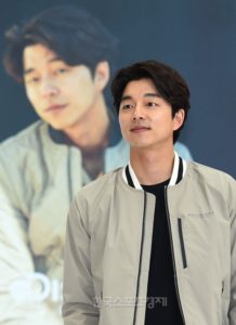 Man wearing a jacket, smiling at camera.