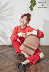 Smiling person with a tan backpack.