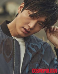 Young man in stylish bomber jacket, posing.