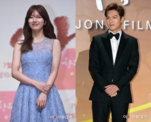 Two smiling individuals in formal attire.