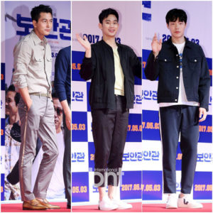 Three men posing at a promotional event.