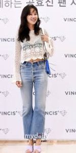 Smiling woman in casual fashion outfit.
