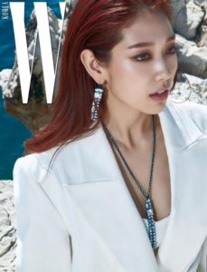 Model wearing stylish jewelry by the coast.