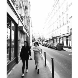 Two women walking down a Parisian street.