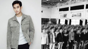 Model poses alongside a blurred crowd.