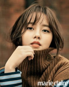 Portrait of a woman in a cozy sweater.