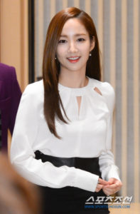 Smiling person in stylish white blouse.