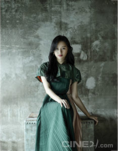Young woman in a stylish green dress.