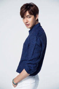 Young man posing in a blue shirt.