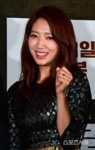 Smiling woman with long, wavy hair.