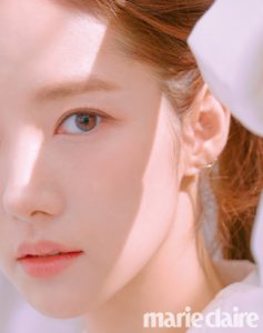 Close-up of a woman's face, soft lighting.