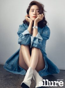 Woman in denim jacket with stylish boots.