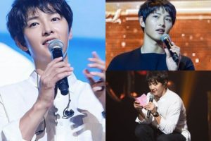 Man speaking into a microphone on stage.